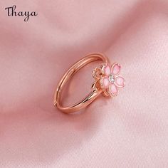 Capture the essence of cherry blossom season with our Silver Sakura Spinner Ring. This elegant piece tells a story of beauty and renewal, as delicate petals bloom and dance in the breeze. The spinner design allows for a soothing sensation, perfect for those seeking balance and serenity in their daily lives. Elevate your style with this stunning symbol of hope and new beginnings.   - Brand: Thaya  - Material: S925 Silver  - Weight : About 2.34g  - Size: Stack Mouth 14th  - Style: Flower  - Gender: Women Delicate Adjustable Rings For Spring, Delicate Spring Flower Ring, Dainty Jewelry For Spring Anniversary, Dainty Jewelry For Anniversary In Spring, Adjustable Rings For Spring Promise Ring, Dainty Spring Jewelry For Anniversary, Delicate Pink Flower Ring For Wedding, Spring Open Ring For Promise, Spring Promise Ring With Open Design