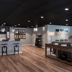 a large open concept living room with wood flooring and white walls on the ceiling