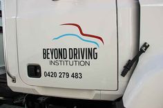 a white truck with the words beyond driving institution on it's side and door