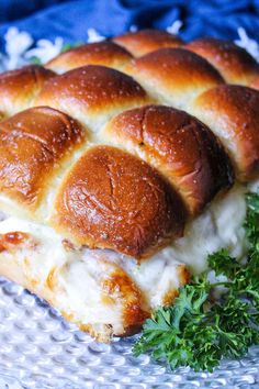 a piece of bread with cheese and meat in it sitting on a glass platter