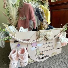 a wooden box filled with baby shoes and other items