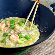 shrimp and vegetable soup in a black bowl with chopsticks