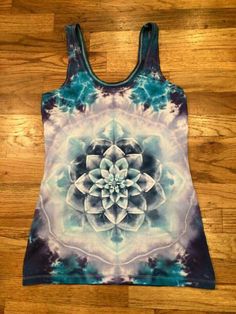 a women's tank top with a blue and white flower design on the front