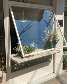 a window that has some flowers in it