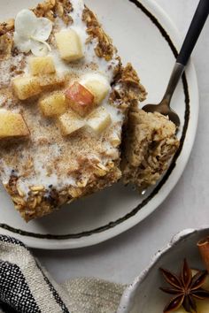 a white plate topped with granola and fruit