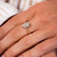 a woman's hand with a diamond ring on it