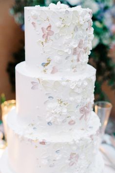 a white wedding cake with flowers on it