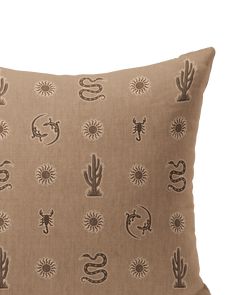 a brown pillow with various cactus designs on it