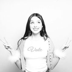 black and white photograph of a woman with peace signs