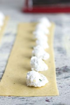 some food is laying out on a yellow piece of paper with white stuff around it