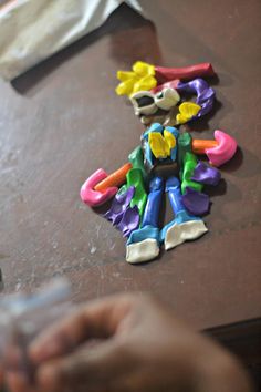 a child is playing with plastic toys on the table and it looks like they have broken their teeth