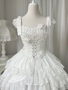 White jacquard fabric corset, under bust neckline and lace trim scallop edge hemline, lace-up closure front, decorated with white roses. Matching wih gothic or elegant classic lolita op and jsk.        	 		 			Size 			S 			M 			L 		 		 			Full Length 			75 			77 			79 		 		 			Bust 			75 			79 			83 		 		 			Waist 			61 			65 			69 		 		 			Shoulders 			34 			35 			36 White Gothic Dress, White Lace Outfit, Goth Fits, Rose Details, White Goth, Lacey Dress, Light Blue Aesthetic, Classic Lolita, Fairy Dresses