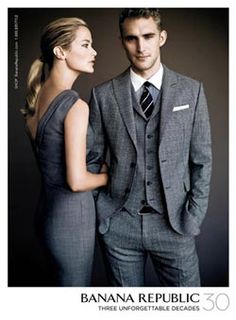 the man and woman are dressed in suits