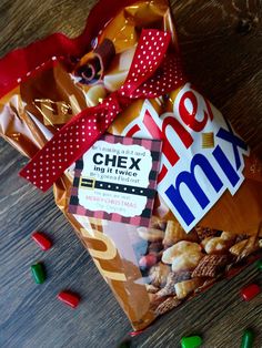 a bag of chex mix sitting on top of a table next to some candy