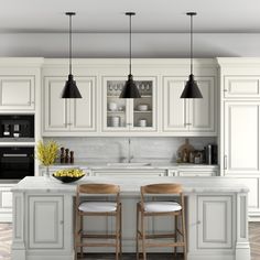 two stools sit at the center of a kitchen island