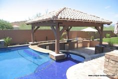 a gazebo next to a swimming pool with an outdoor grill and seating area in the background