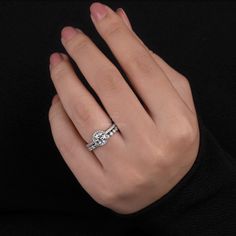 a woman's hand with a diamond ring on it