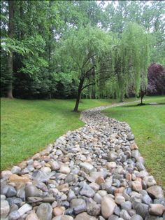 a stone path in the middle of a grassy area