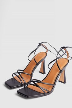 This strappy sandal is high-heeled and features a self tie closure. It has a square toe. Measurements in size 39: Heel height: 9 cm / 3.5 in. Vacation Strappy Heels, Affordable Black Trendy Slingback Sandals, Luxury Black Square Toe Heels, Small Heel Shoes Strappy, Cheap Square Toe Heels For Night Out, Black Strappy Heels Nordstrom, Strappy Black Heel Shoe, Affordable Black Flat Heel T-strap Sandals, Black Strappy Heels