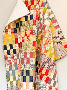 a colorful quilt hanging on the wall