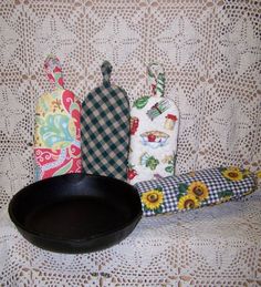 a cast iron skillet sitting on top of a table next to decorative kitchen utensils