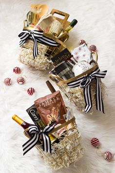 two small baskets filled with holiday gifts on top of a white furnishing covered floor