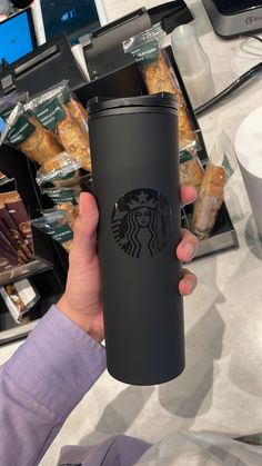 the starbucks cup is being held up by someone