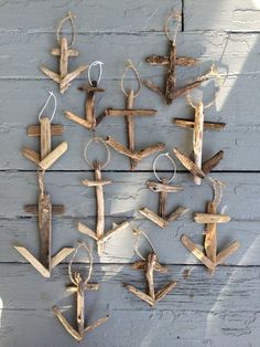 several pieces of driftwood are arranged in the shape of an airplane on a wall