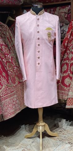 This taupe pink simple perfect attire for his perfect wedding event. This exquisite sherwani is enriched in zardosi, stones & thread on the mandarin collar and the designer buttons are rightly sufficing the attire.Available with matching chudidar. Size: 38,40,42,44,46 Ready to Ship! Luxury Long Sleeve Pink Sherwani, Luxury Pink Sherwani Straight Kurta, Luxury Pink Sherwani For Eid, Luxury Pink Sherwani With Zari Work, Pink Sherwani, Designer Buttons, Wedding Event, Mandarin Collar, Perfect Wedding