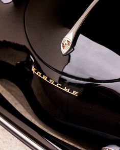 the emblem on the side of a black porsche car is seen in this close up photo