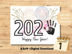 a happy new year card with fireworks and handprints on it, next to a calendar