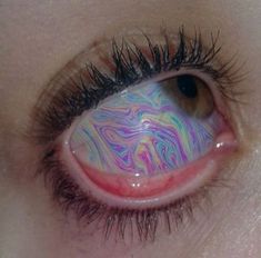 an eye with colorful swirls painted on it's iris and black mascara lashes