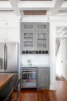 a kitchen with stainless steel appliances and wooden floors