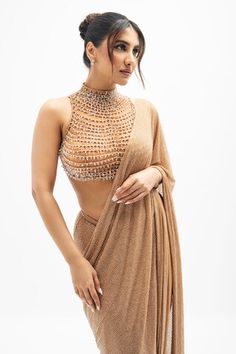 Brown pre-draped saree with crystal embellishments. Paired with a high neck blouse with crystal droplet embellishments. - Aza Fashions Embellished Tops For Evening With Traditional Drape, Fitted Top With Sheer Dupatta For Evening, Bollywood Style Traditional Drape Evening Tops, Party Wear Top With Traditional Drape For Reception, Party Wear Embellished Top With Traditional Drape, Evening Party Wear Tops With Traditional Drape, Glamorous Draped Choli For Reception, Glamorous Draped Embellished Blouse Piece, Glamorous Draped Embellished Choli