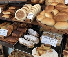 many different types of breads and pastries on display