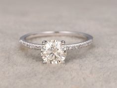 a diamond engagement ring with diamonds on the side