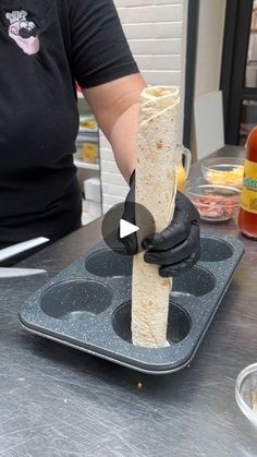 a person is making some food on a tray