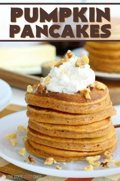 a stack of pumpkin pancakes with whipped cream on top and the title overlay reads pumpkin pancakes