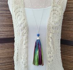 This tassel necklace is made from Sari Silk ribbon.  What I love about the Sari Silk ribbon that I used here is that it made from silk scraps that poor women in India gather from factory floors. They then sew them together to sell to support their families. There is a wood bead on the top of the tassel. This necklace comes on a 30 inch chain (if you would like a shorter or longer chain just make a note on your order. I will replace it for you).  This necklace comes packaged in an organza gift bag with the story of The Broken Shell* and the information that all proceeds from this sale will be used by Huruma Ministries to minister to orphans and widows in Kenya. Sari Silk Ribbon, Women In India, Sari Silk, Organza Gift Bags, How To Make Notes, Silk Ribbon, Wood Beads, Long Necklace, Kenya