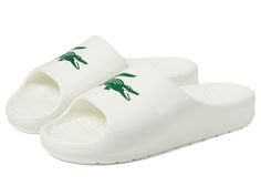 Lacoste Serve Slide 2.0 223 1 CMA - Men's Shoes : Off-White/Dark Green : Spend a day in ultimate relaxation and comfort donning the Lacoste Serve Slide 2.0 223 1 CMA. Featuring an injection-molded EVA foam construction, these slippers deliver superior cushioning comfort and arch support. They are made with a synthetic upper with a contrasting logo print, a synthetic lining, and a padded footbed. Easy slip-on style. Round open toe. Synthetic outsole. Imported. White Synthetic Slippers For Leisure, White Cushioned Slippers For Leisure, Comfortable White Synthetic Slides, Sporty Synthetic Slippers, Sporty Synthetic Leisure Slippers, Sporty Synthetic Slippers For Leisure, Sporty Synthetic Slides, Sporty White Non-slip Slippers, Casual White Slides