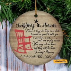 a personalized christmas ornament with a red rocking chair hanging from a tree