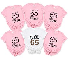 six baby girls'shirts with the number 65 on them in pink and white, one is