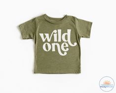 Wild One Shirt ------DETAILS------ Design made with high quality vinyl, not printed! Design is heat pressed onto garment using vinyl Can be machine washed and dried For longer durability, turn inside out, wash cold and lay out to dry ------GARMENT OPTIONS------ --Bella + Canvas-- Super Soft! 100 % combed and ring spun cotton Grey 90% combed and ring spun cotton and 10% polyester 100% No Sweatshops & Eco-Friendly ----- PROCESSING TIME ----- If needed by a certain time please contact us to see if Wild One Birthday Shirts For Family, Green Custom Print T-shirt For Birthday, Casual Pre-shrunk T-shirt For First Birthday, Green Cotton T-shirt For First Birthday, Green Graphic Print T-shirt For First Birthday, Unisex Cotton Birthday Shirt, Unisex Pre-shrunk T-shirt For First Birthday, Green Letter Print T-shirt For Birthday, Casual Text Print T-shirt For First Birthday