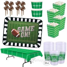 football party supplies including cups, trays and tableware for game on with green striped napkins