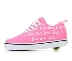 a pink skateboard shoe with white lettering on the side and green rubber soles