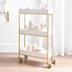 a gold and white cart with cosmetics on it