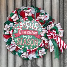 a wreath with the words jesus is the reason for the season on it and candy canes