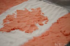 pink and white powdered food sitting on top of a table