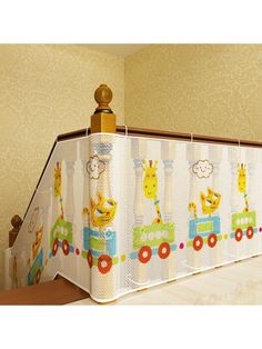 a baby crib with giraffes and train curtains on it's sides