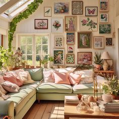 a living room filled with lots of furniture and pictures on the wall above it's windows